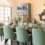 4 BHK Isprava Villa Viastro Pernem Goa Dining Room with Green Chairs and Display Cabinet
