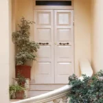 4.5 BHK Isprava Lumosa Aldona Goa Entrance With White Double Doors And Potted Plants