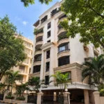 Cannon Bandra West Low Rise Residential Block With Arched Balconies Palm Trees