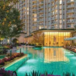 Hiranandani Maitri Park Chembur Turquoise Lap Pool Beside Glass Fronted Clubhouse With Sun Loungers