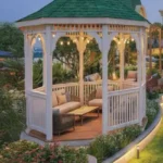 One Vara Goregaon White Gazebo With Green Roof Surrounded By Lush Landscaped Garden Seating
