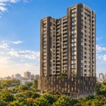 Sahakar Acropolis Kala Nagar Bandra East High-Rise Tower Facade Surrounded By Lush Greenery Under A Bright Blue Sky