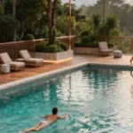 The Altimus Khar West Serene Outdoor Pool With Timber Sun Deck Loungers And Lush Greenery