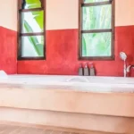 Veda Monteza Plots for Sale Alibaug Built in Bathtub with Red Walls and Tall Windows