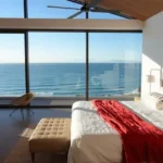 W 291 Sambhav Walkeshwar Sea Facing Bedroom With Red Bedspread And Ceiling Fan
